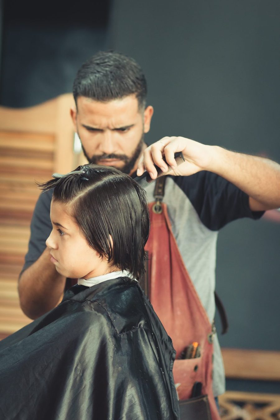 Gentleman cutting little boy's hair